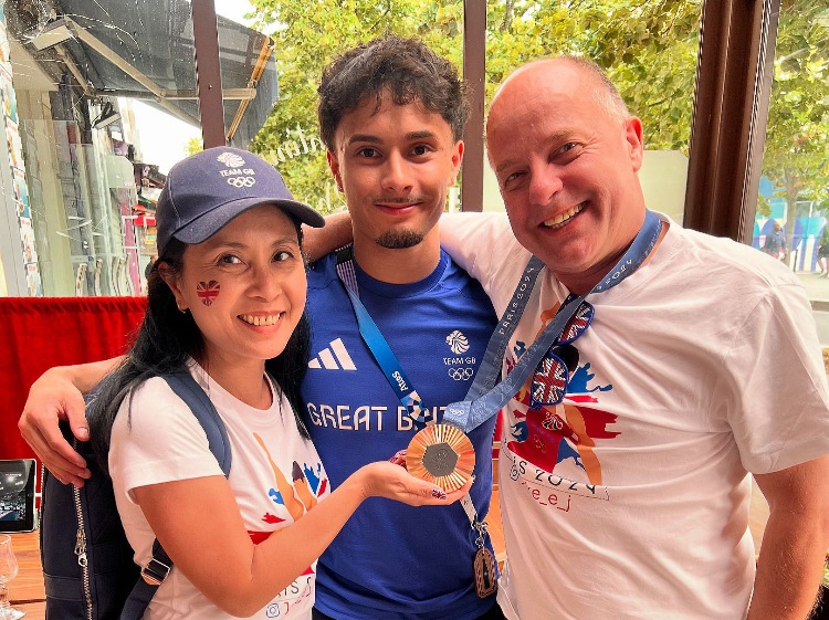 Jake Jarman shows off his bronze medal in Paris with proud parents Ana and Tony