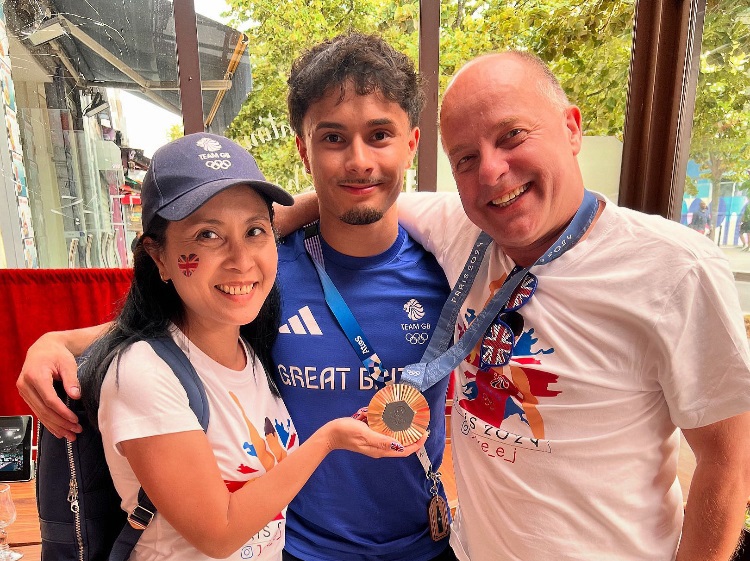 Jake Jarman shows off his bronze medal in Paris with proud parents Ana and Tony